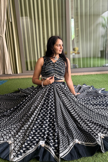 This mesmerizing black lehenga choli set features traditional block prints